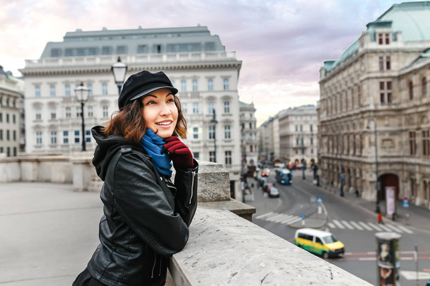 Young Asian woman tourist on the street in the center of Vienna smiling at winter - Фото, изображение