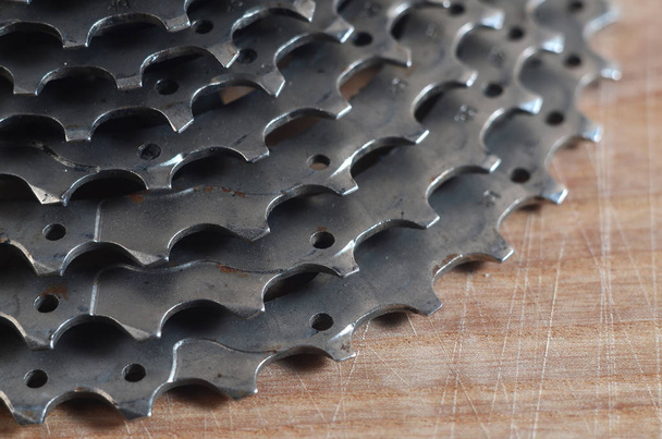Rear cassette (sprocket) from a mountain bike lying on a wooden  - Photo, Image