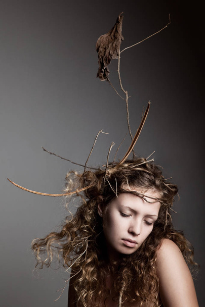 portrait of woman with branches in hair - Foto, afbeelding