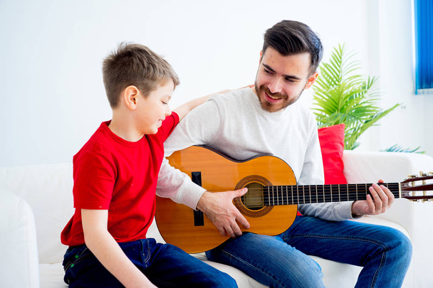 Father and son playing guitar - Foto, imagen
