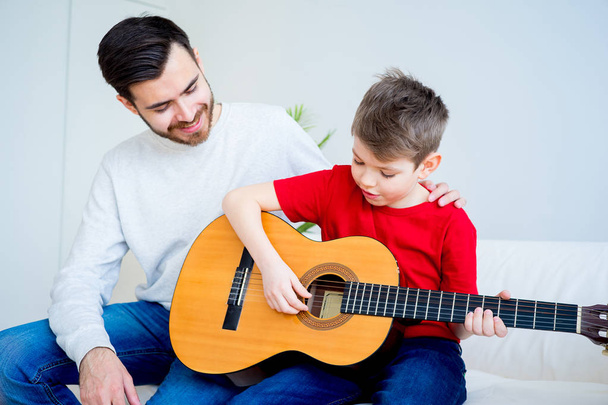 Father and son playing guitar - Fotoğraf, Görsel