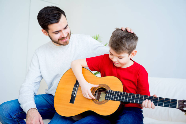 Father and son playing guitar - Фото, зображення