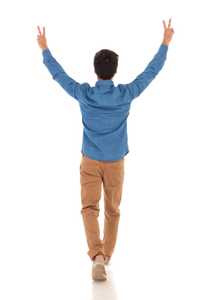 back view of a casual man celebrating victory and walking - Photo, image