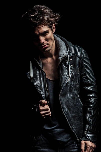 young biker in leather jacket pulling his collar - Photo, Image