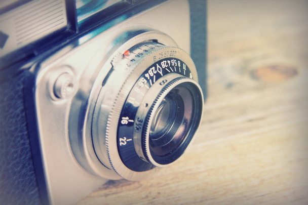 Old vintage retro camera on wooden background - Photo, Image
