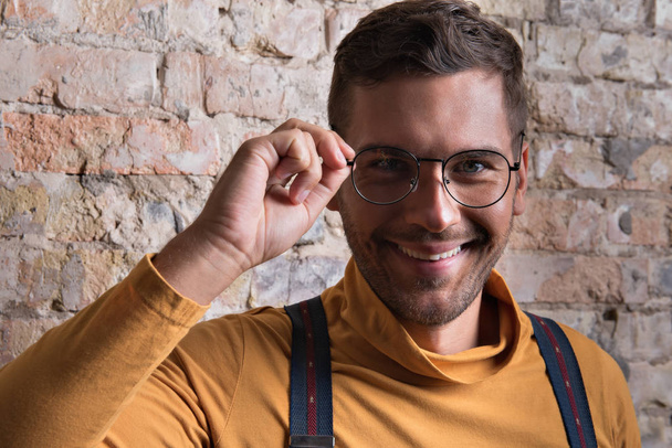 Positive young bearded man posing with smile - Photo, image