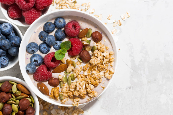 muesli with yogurt and berries for breakfast on white background - Фото, изображение