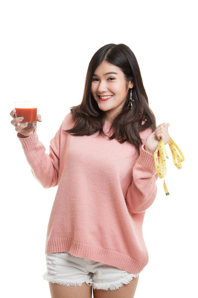 Asian woman with tomato juice and measuring tape. - Foto, imagen