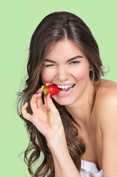 Young girl eating strawberry - Fotografie, Obrázek