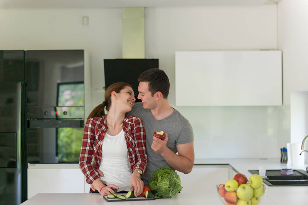 Young handsome couple in the kitchen - Foto, imagen