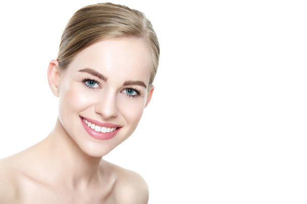 Beautiful young blond smiling woman with clean skin, natural make-up and perfect white teeth white background - Valokuva, kuva