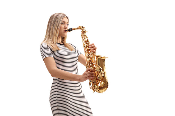 Young woman playing a saxophone - Foto, imagen