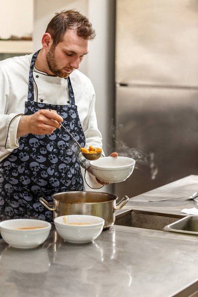 Chef is pouring soup  - Foto, afbeelding