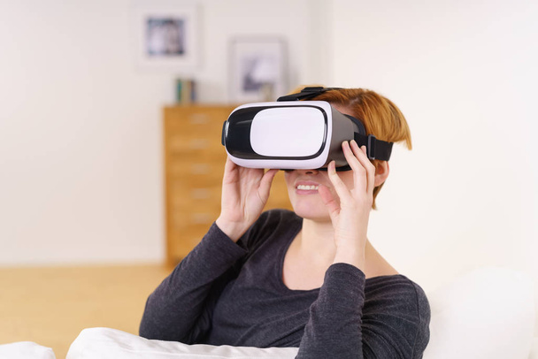 Woman using VR headset - Фото, изображение