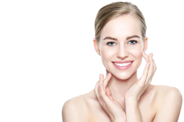 Beautiful Young Blond Woman with Perfect Skin touching her face. Facial treatment. Cosmetology, beauty and spa concept. Isolated on white background. - Φωτογραφία, εικόνα