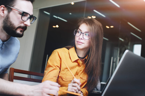Bearded business man and a girl in glasses at a meeting working  - Photo, Image