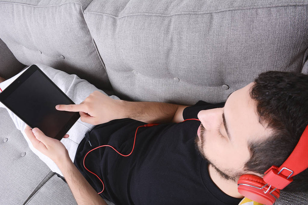 Man listening music with tablet. - 写真・画像