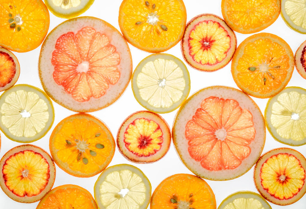 Bright sweet citrus slices on white - Фото, изображение