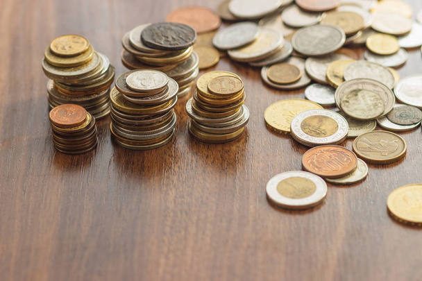 Different gold and silver collector's coins on the wooden table - Photo, Image