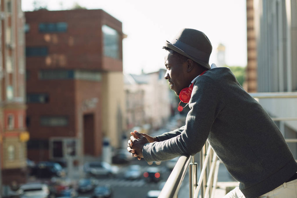 African american man with headphones looking at city - 写真・画像