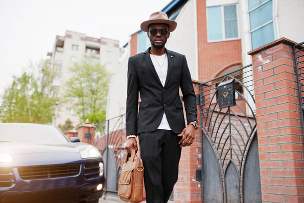 Stylish black man at glasses with hat, wear on suit with handbag - Fotó, kép