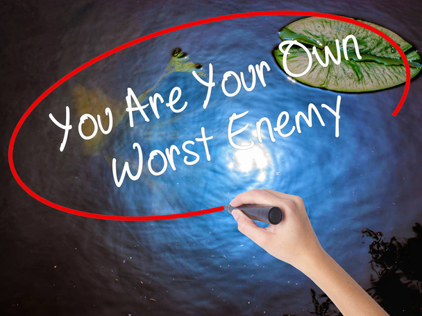 Woman Hand Writing You Are Your Own Worst Enemy with marker over - Photo, Image