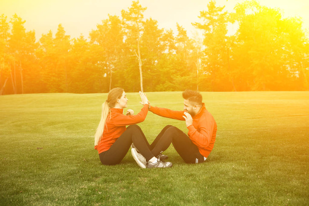 Sport man and woman training in park - Photo, Image