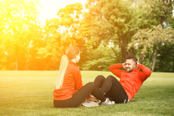 Sport man and woman training in park - Photo, Image