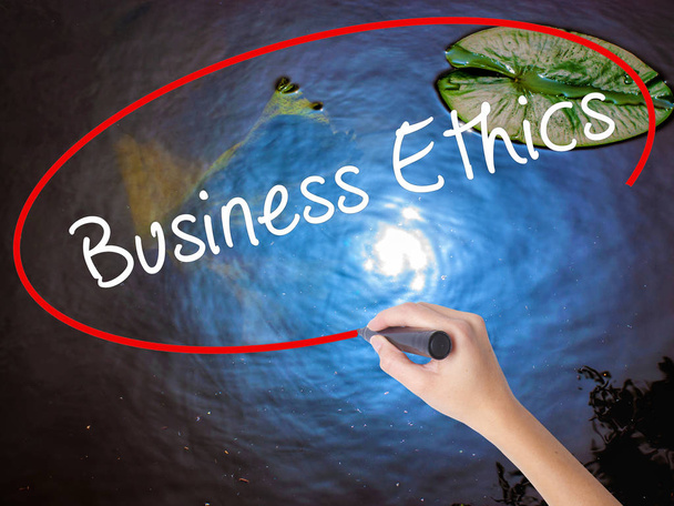 Woman Hand Writing Business Ethics with marker over transparent  - Photo, Image