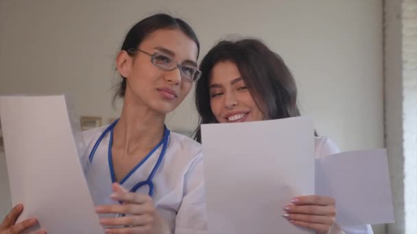 Two doctors with paper documents. - Filmati, video