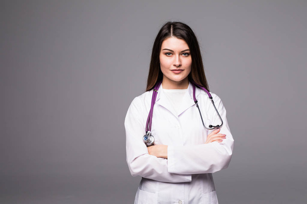 Woman doctor standing isolated on grey background - Photo, image