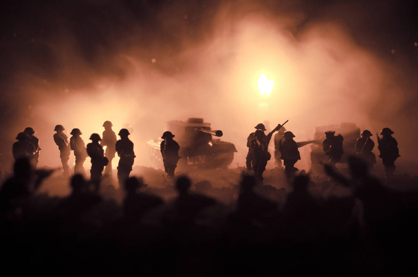 War Concept. Military silhouettes fighting scene on war fog sky background, World War Soldiers Silhouettes Below Cloudy Skyline At night. Attack scene. Armored vehicles - Photo, Image