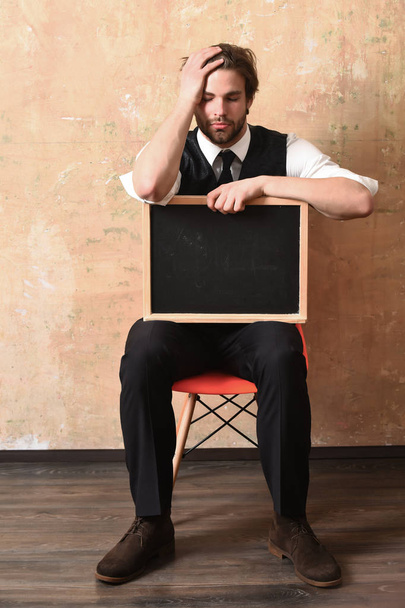 student or tired businessman holding a blackboard - 写真・画像