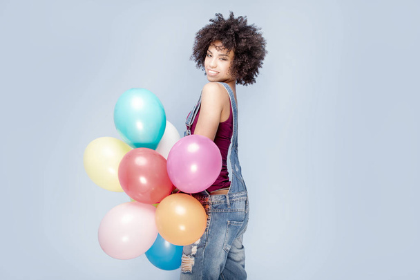 Happy young girl with afro holding balloons. - Foto, Imagem