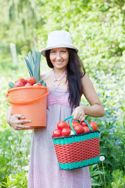 Happy woman holds vegetables harvest - Valokuva, kuva