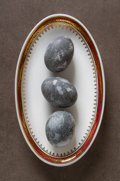 Easter composition with gray eggs on a colored background, space - Photo, image