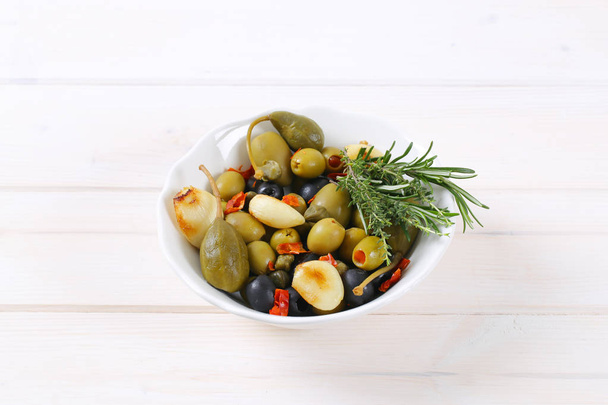 pickled olives, capers, caper berries and garlic - Фото, изображение