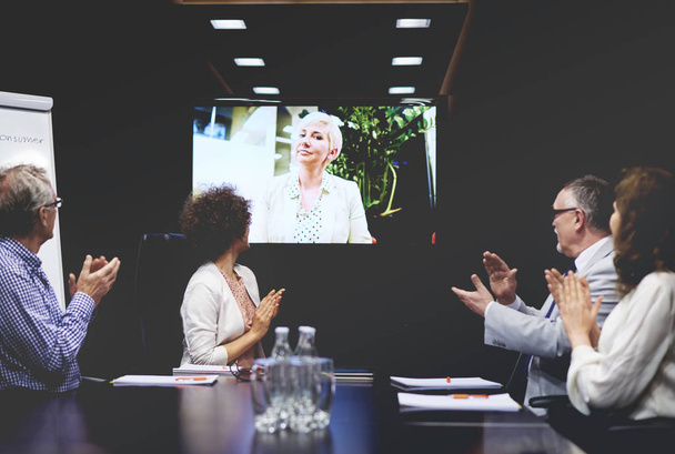 Business people clapping for colleague on video call  - Photo, Image