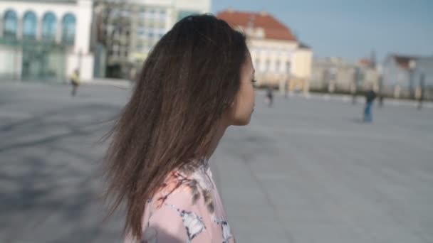 Portrait of a young woman walking in the city streets. - Záběry, video