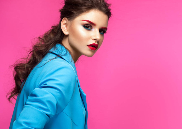 Beautiful girl in blue suit on pink background with creative make-up and fashionable style. Beauty face. - Φωτογραφία, εικόνα