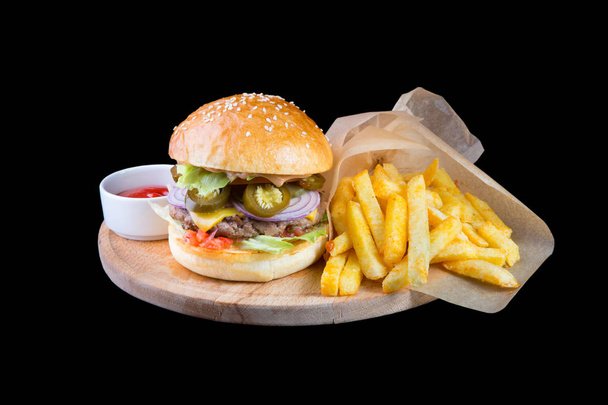 Burger with french fries isolated on a black background - Valokuva, kuva