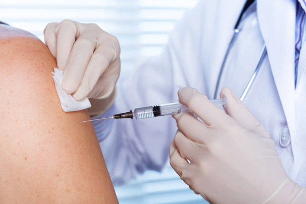 Doctor making a vaccination - Photo, image
