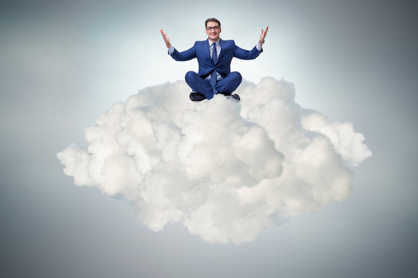 Businessman sitting at top cloud - Photo, Image
