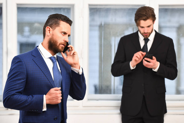 men or businessmen speaking on mobile phone near window - Photo, Image