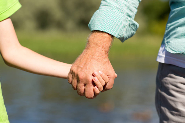 senior man and child holding hands - Photo, image