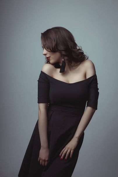 Sensual woman in black dress posing at studio   - Φωτογραφία, εικόνα