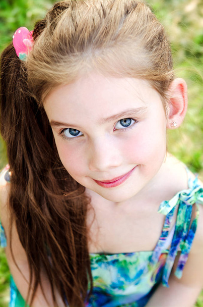 Portrait of adorable smiling little girl outdoor  - Photo, Image