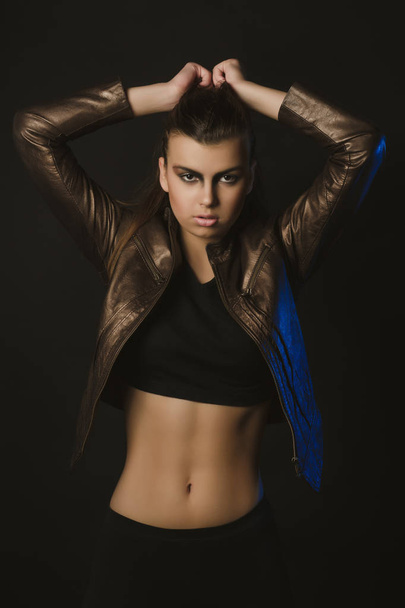 Glamorous woman with creative makeup  in brown leather jacket po - 写真・画像