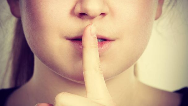 Woman showing silence gesture with finger - Photo, image