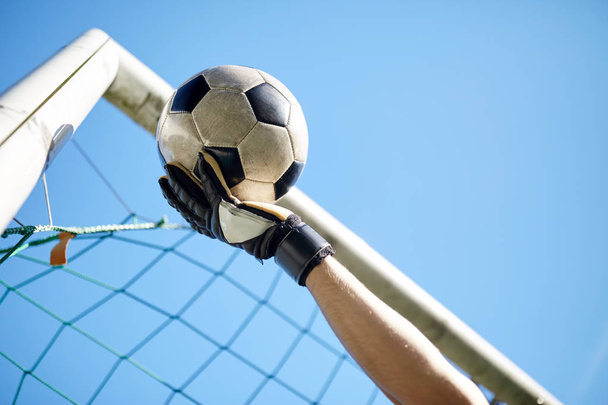 goalkeeper with ball at football goal over sky - Zdjęcie, obraz